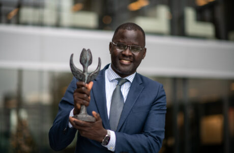 Nicholas Opiyo holding a prize