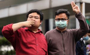 A human rights lawyer Arnon Nampa and a protest leader, Parit "Penguin" Chiwarak flash three-fingers salute in Bangkok