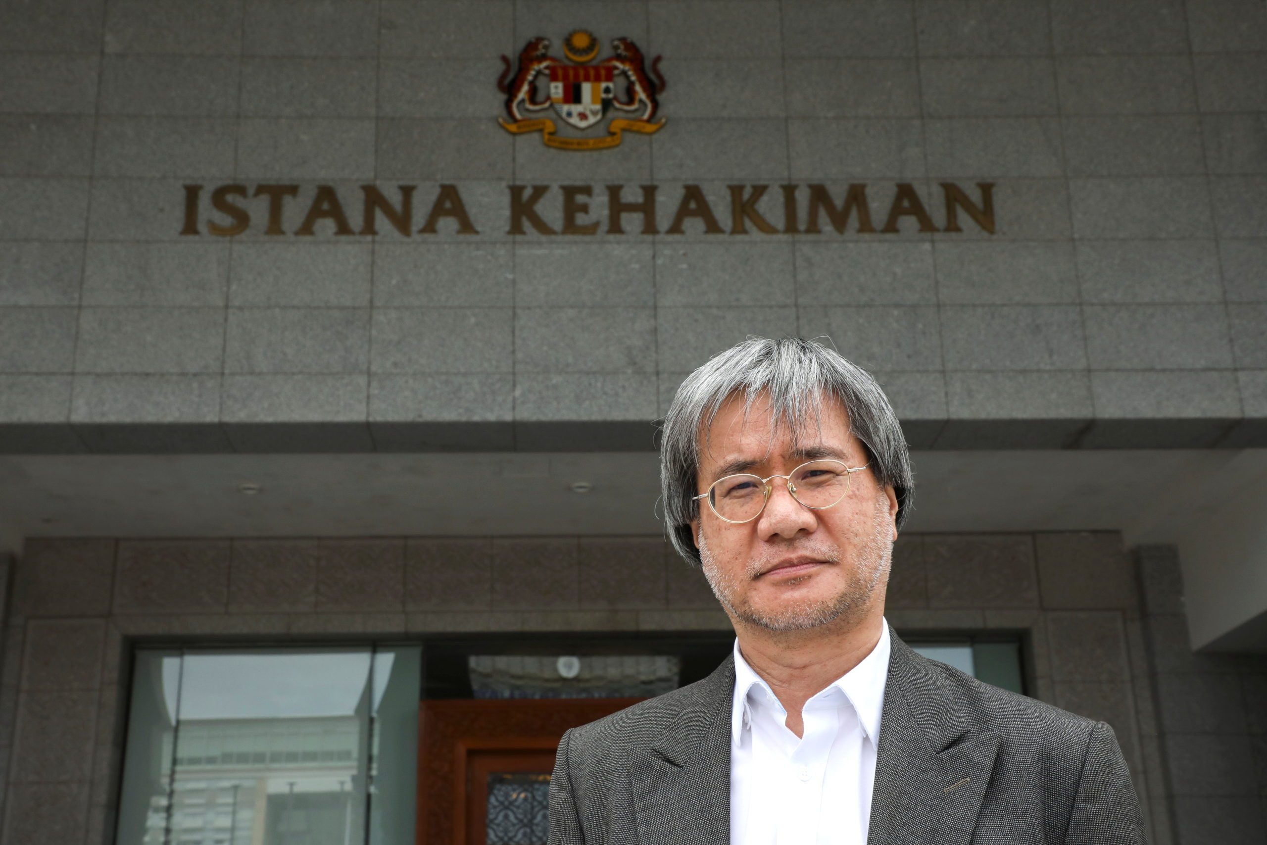 Malaysiakini's editor-in-chief Steven Gan poses for a picture outside the Federal Court in Putrajaya