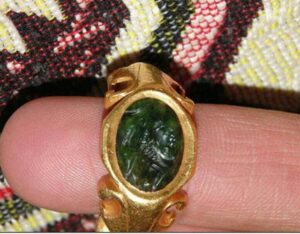 A gold ring with carved gemstone
