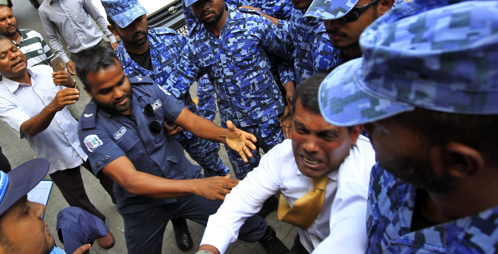 Former President of the Maldives, Mohamed Nasheed, being arrested