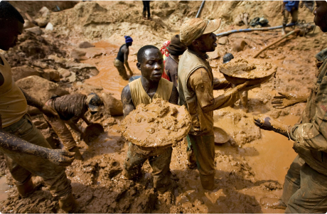 Men mine for tin ore in a pit in eastern Congo