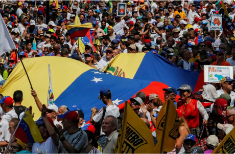 Protesters in Venezuela carry the flags of their country