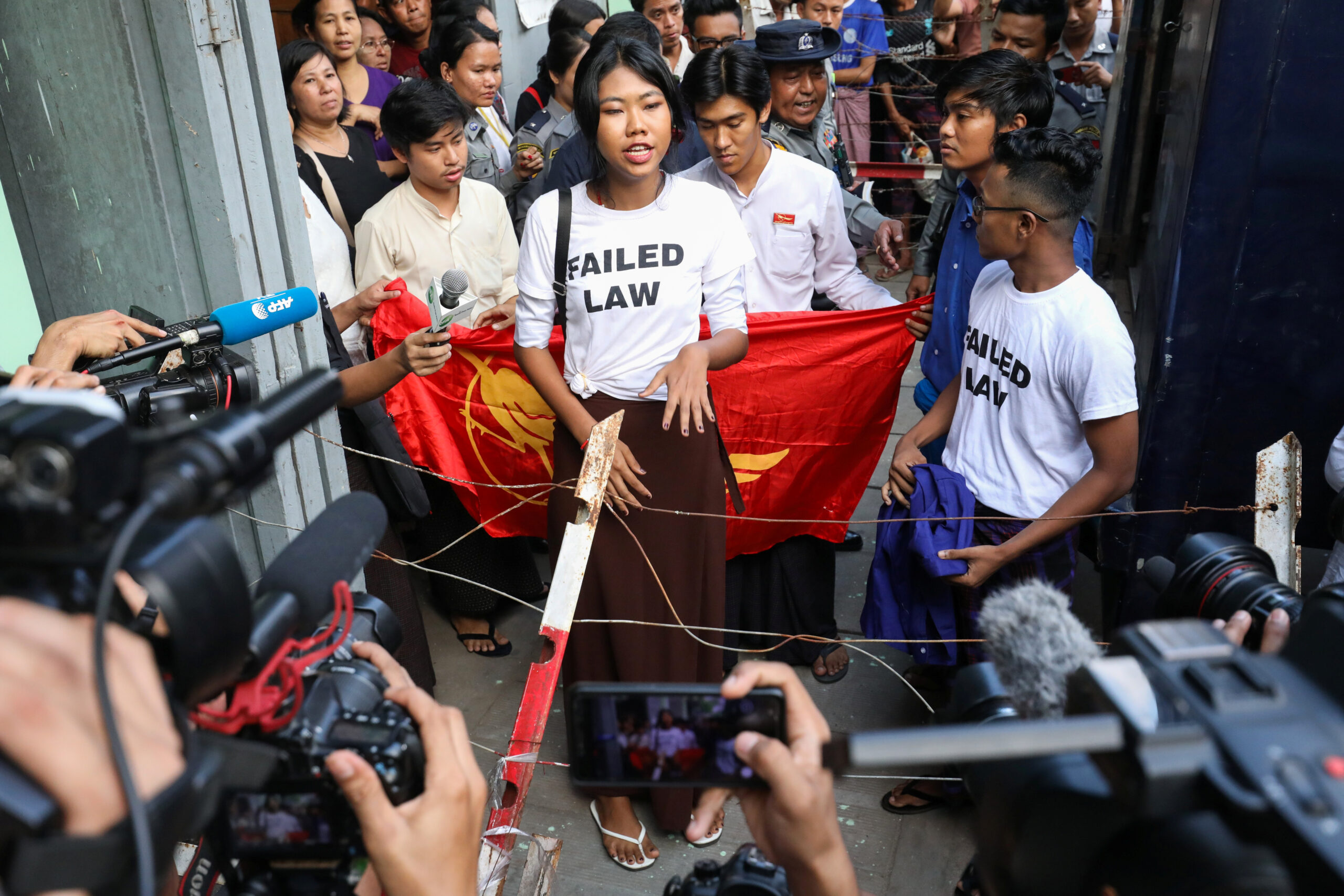 A member of a satirical poetry troupe speaks to media outside of Botataung court in Yangon, Myanmar.