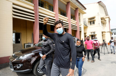 Eromosele Adene, who took part in protests against alleged police brutality, gestures while leaving court following the adjournment of his hearing