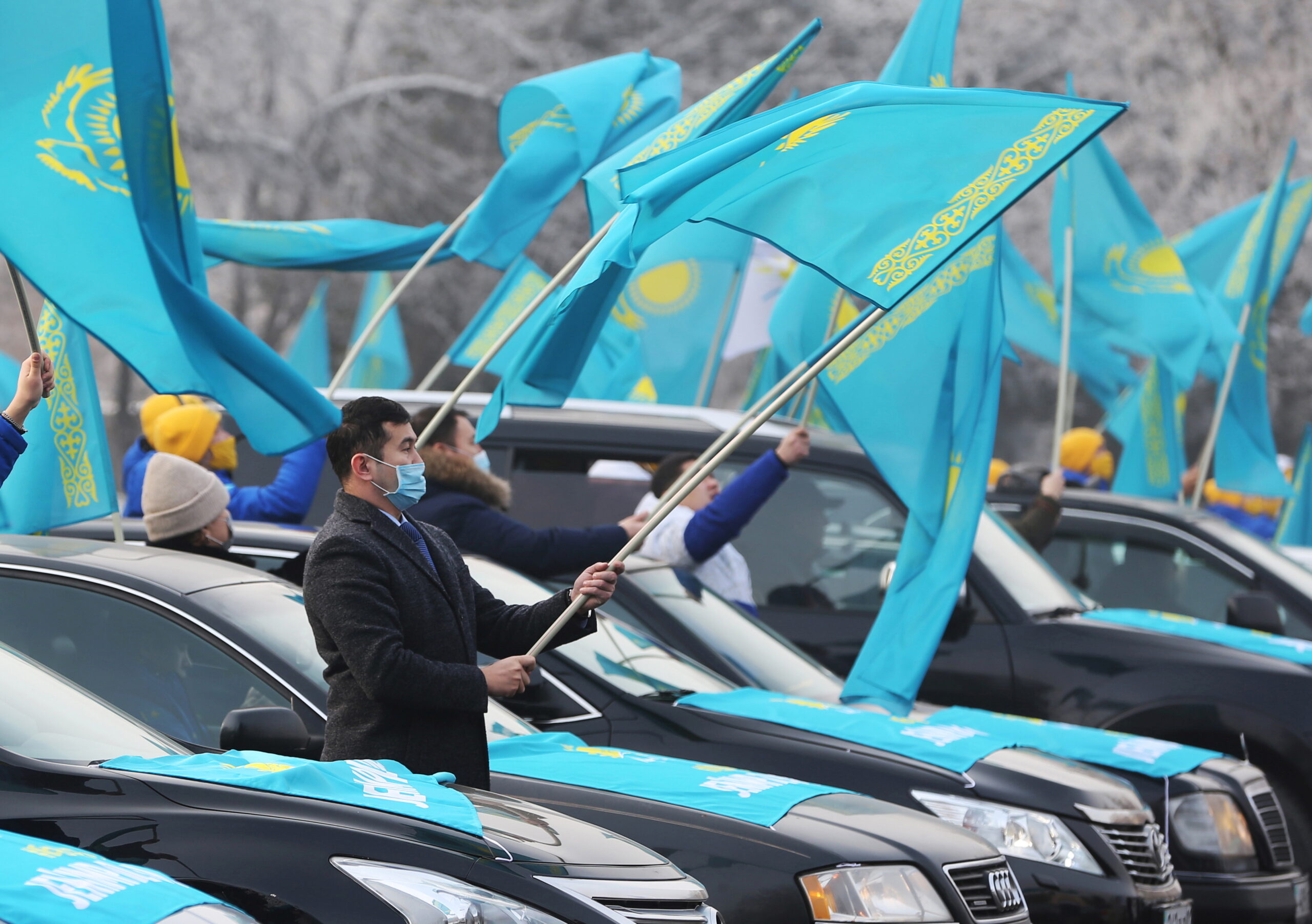 Supporters of the Nur Otan ruling party wave national flags during a pre-election rally in Almaty, Kazakhstan.