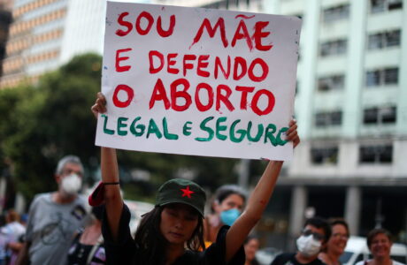 A woman holds a sign reading "I am a mother and I support legal and safe abortion" during a demonstration to mark International Women's Day, in Rio de Janeiro, Brazil, March 8, 2022.