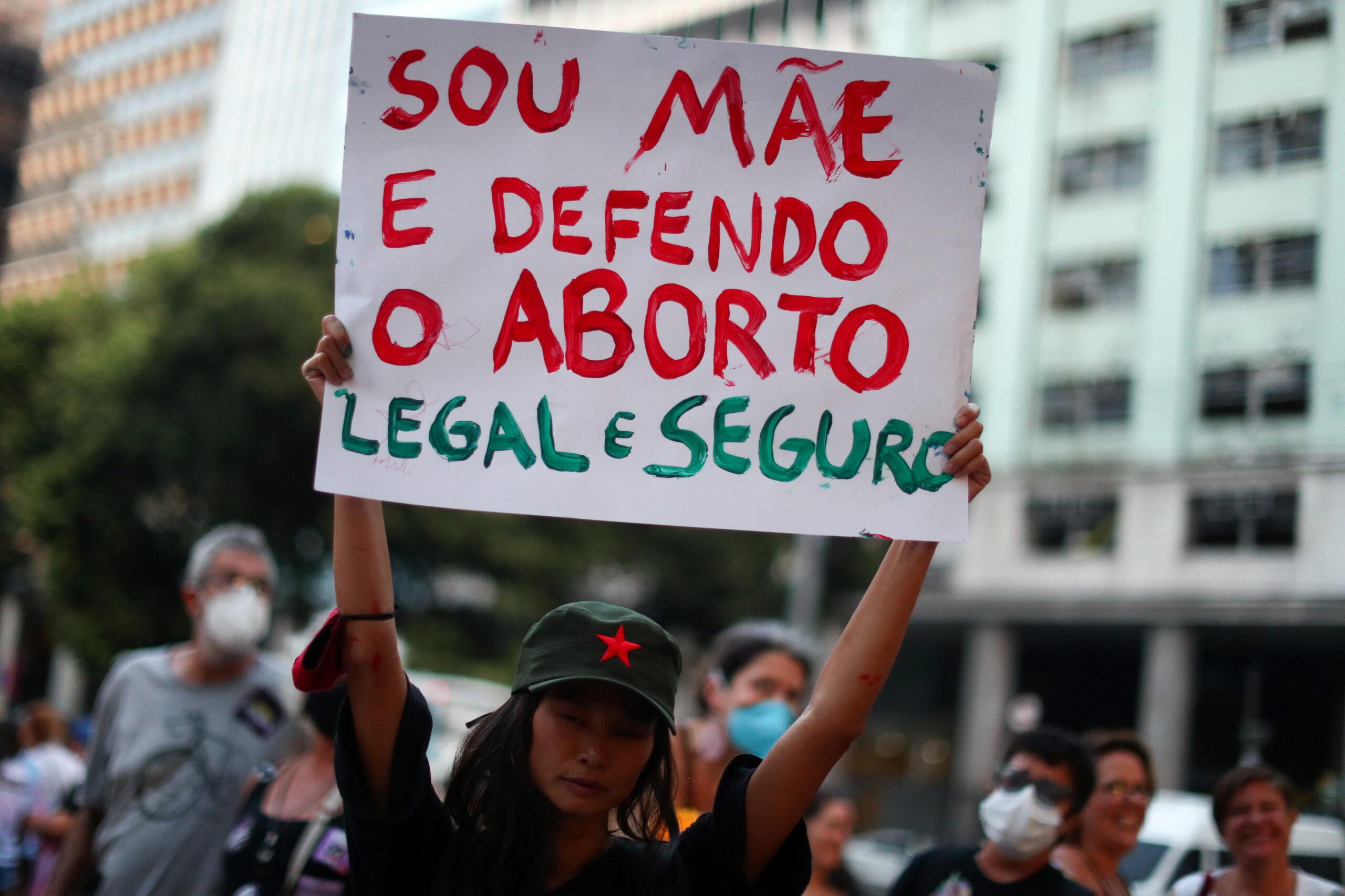 A woman holds a sign reading "I am a mother and I support legal and safe abortion" during a demonstration to mark International Women's Day, in Rio de Janeiro, Brazil, March 8, 2022.
