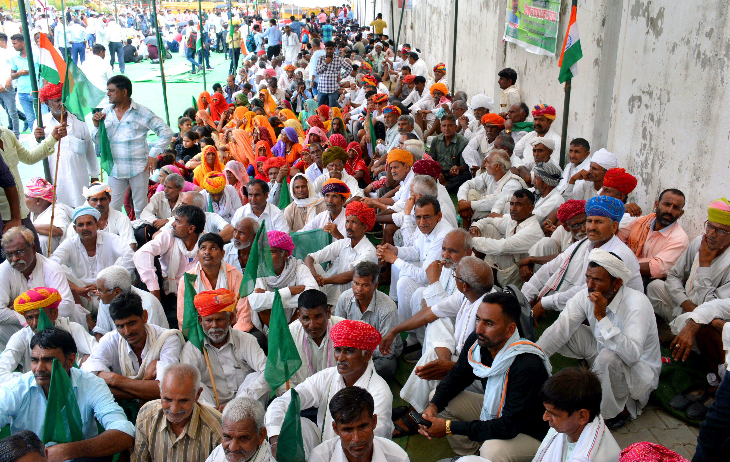 Farmers sitting on the ground as part of a protest demanding water to every field and fair price for the crops in India