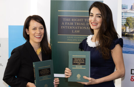 Philippa Webb and Amal Clooney hold copies of their book 'The Right to a Fair Trial in International Law'