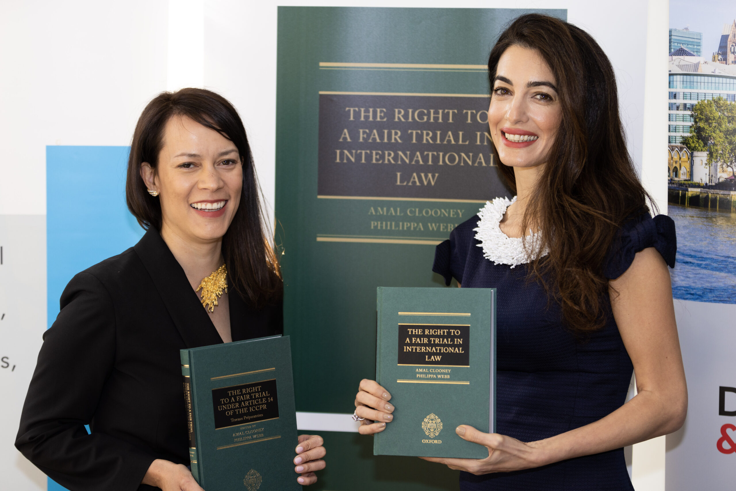 Philippa Webb and Amal Clooney hold copies of their book 'The Right to a Fair Trial in International Law'