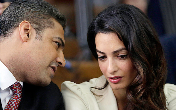 Amal Clooney talks to her client, Al-Jazeera journalist Mohamed Fahmy