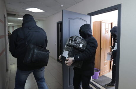 Law enforcement officers leave the office of the independent Belarusian Association of Journalists (BAJ) during a search in Minsk, Belarus