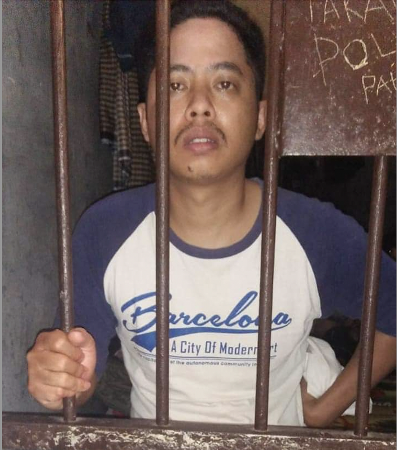 Indonesian journalist Muhammad Asrul behind behind bars