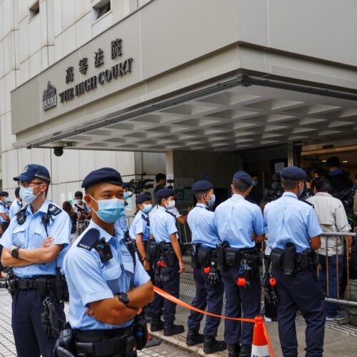 Security forces stand outside the High Court in Hong Kong