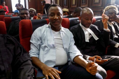 Omoyele Sowore sitting with lawyers in court