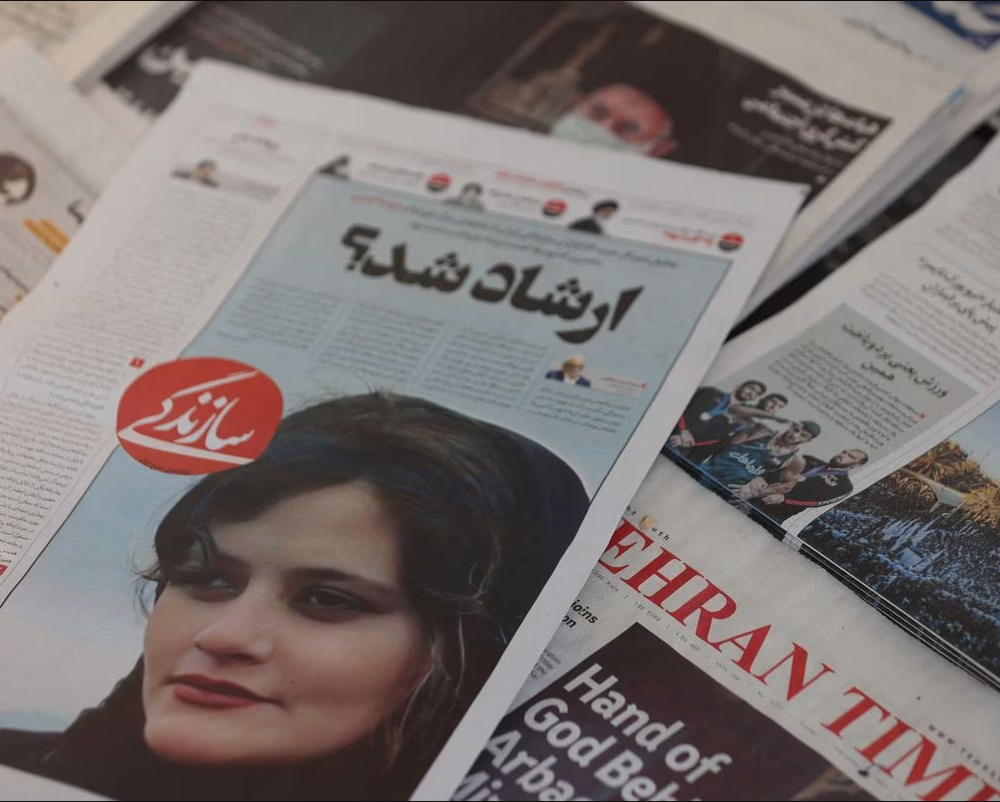 Iranian newspaper covers with the face of Masha Amina on them.