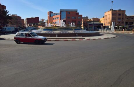 A car drives by a roundabout in Western Sahara