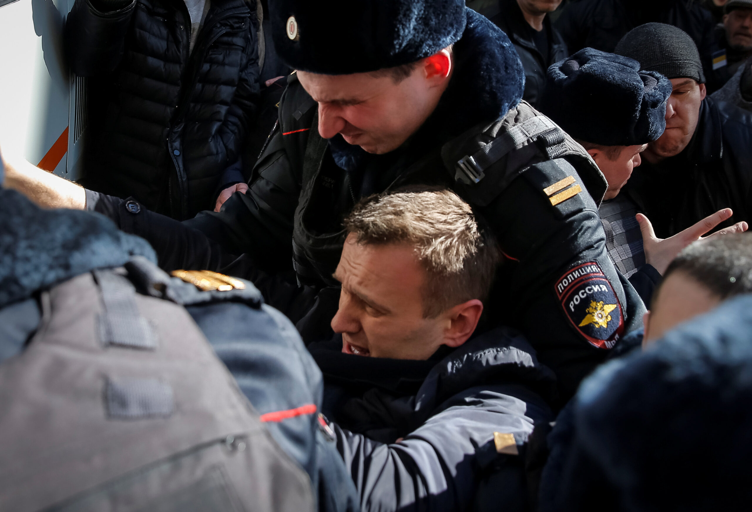 Police officers detain anti-corruption campaigner and opposition figure Alexei Navalny during a rally