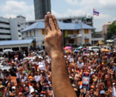 A protester makes three finger salute during the demonstration in Thailand.