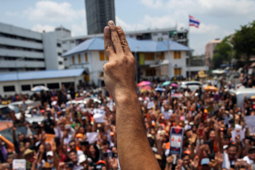 A protester makes three finger salute during the demonstration in Thailand.