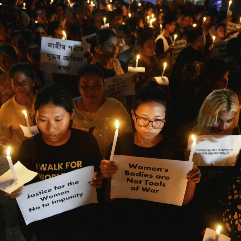 Members of the Alliance of Feminist Collectives stage a candle march over the sexual assault against women and the ongoing ethnic violence in the north-eastern state of Manipur, in Guwahati