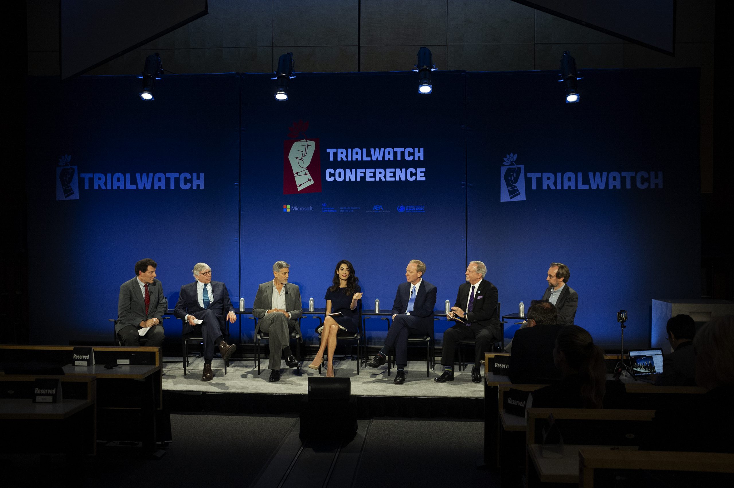 The panel of speakers at the TrialWatch Conference with George and Amal Clooney