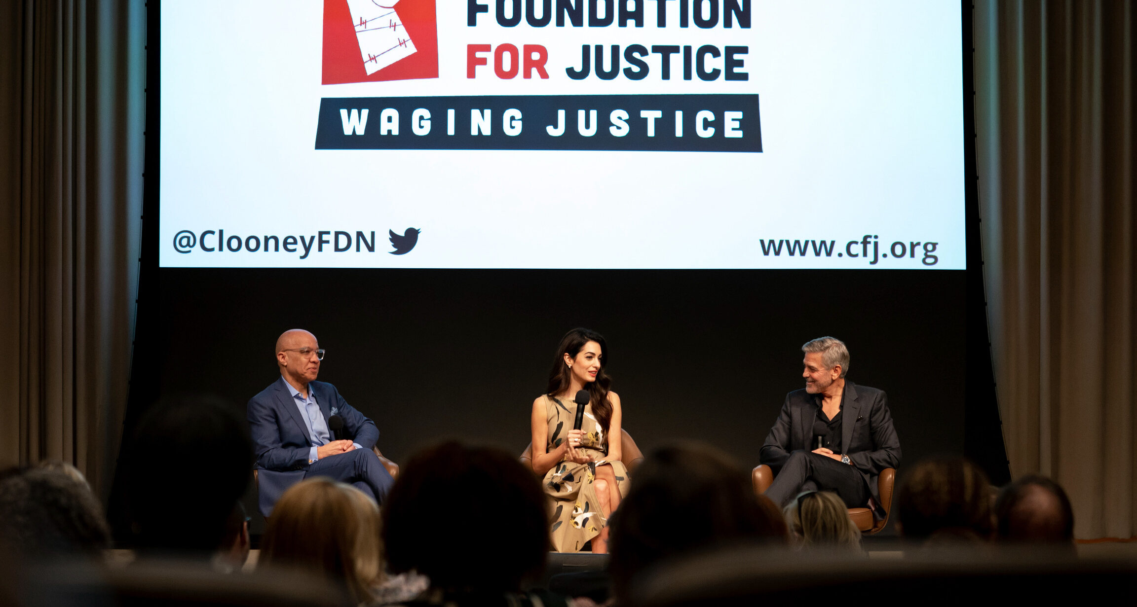 Darren Walker, CFJ board member and president of the Ford Foundation, and Amal and George Clooney speak at a panel revealing the winners of the first Albies awards offered by the Clooney Foundation for Justice in 2022
