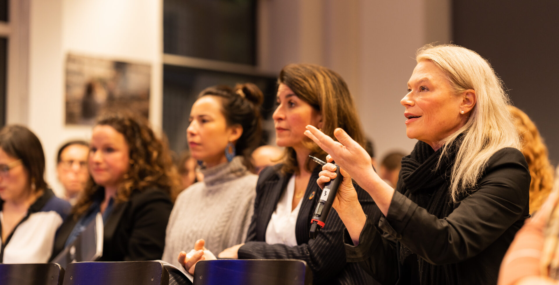 Attendees of launch event of CFH's Justice Beyond Borders project in the Hague, with one of them asking a question