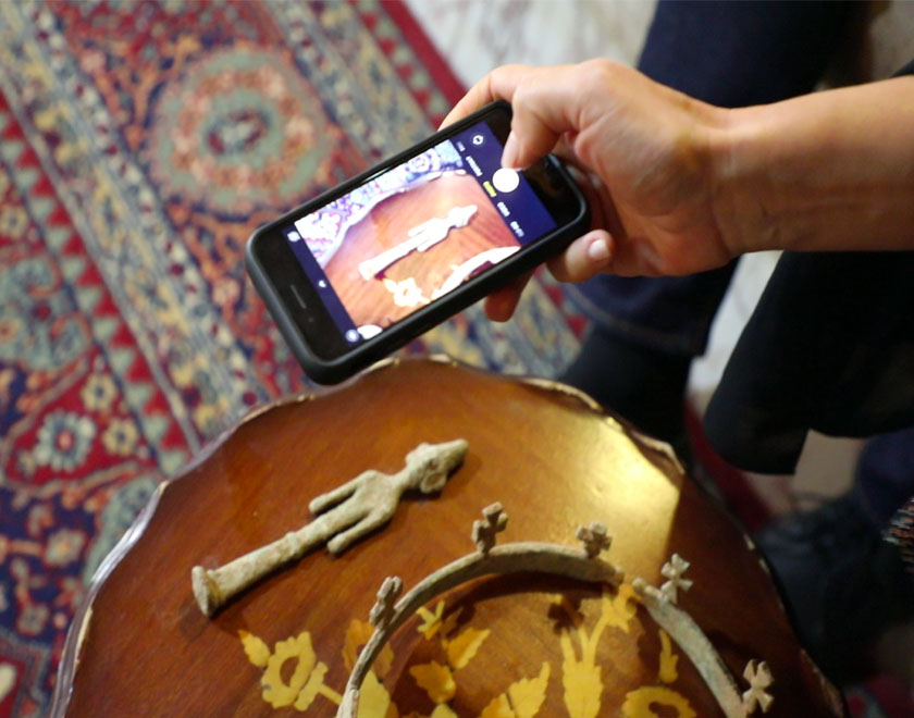 A person photographing looted items that were presented to the Docket team in Lebanon