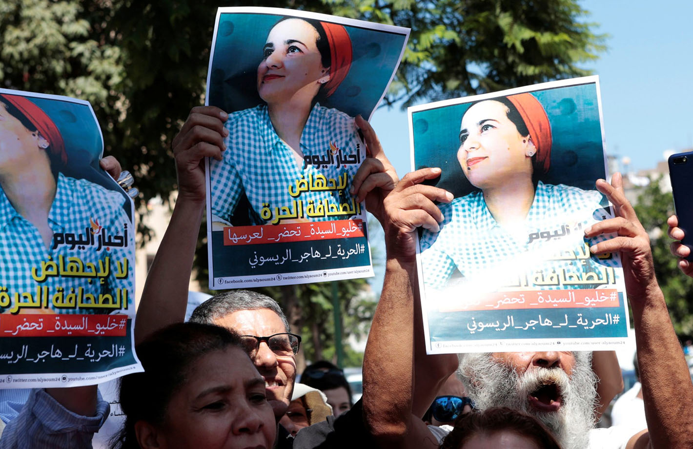 Protesters in Morocco hold posters demanding the freedom of journalist Hajar Raissouni