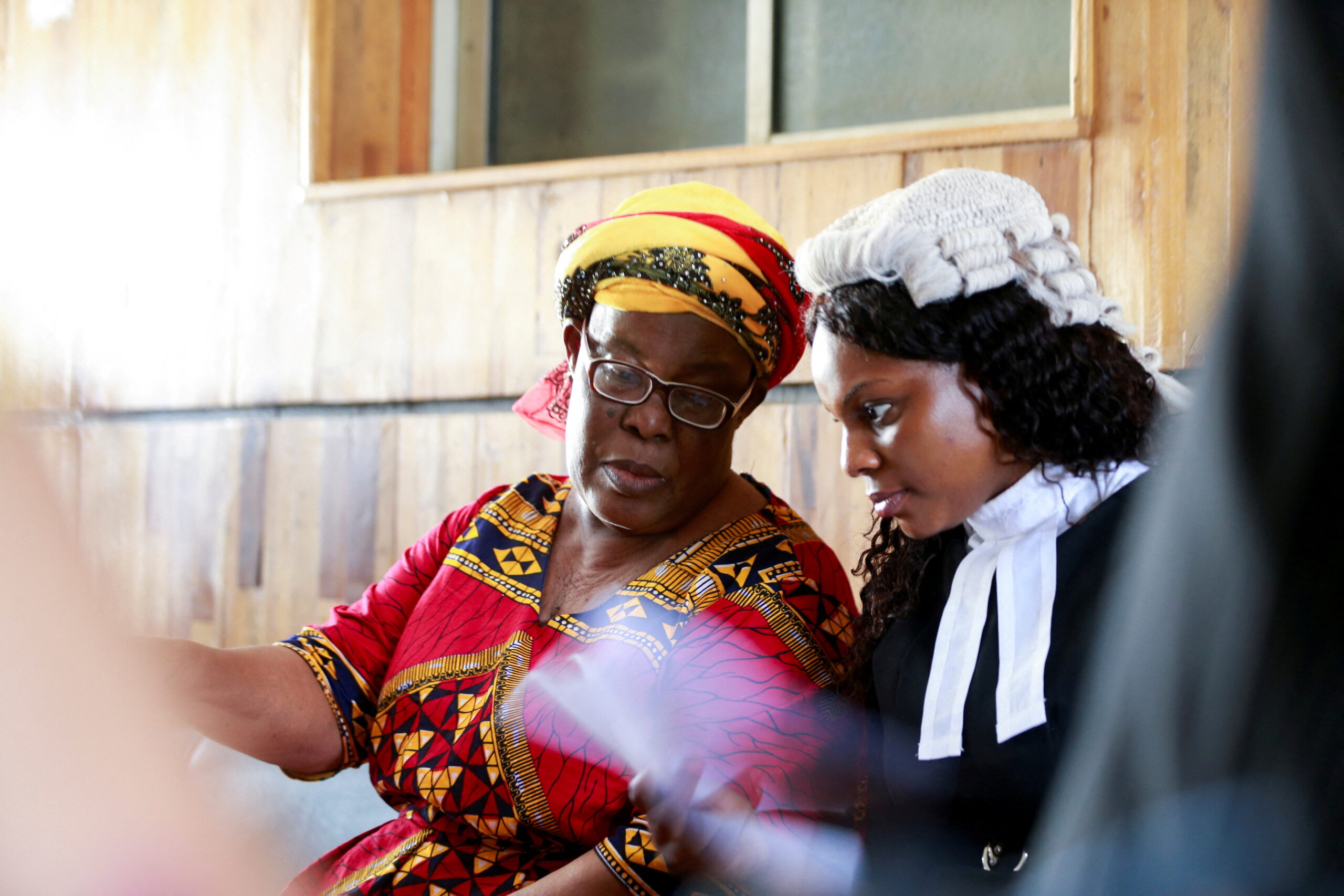 A woman lawyer talking to her client at court
