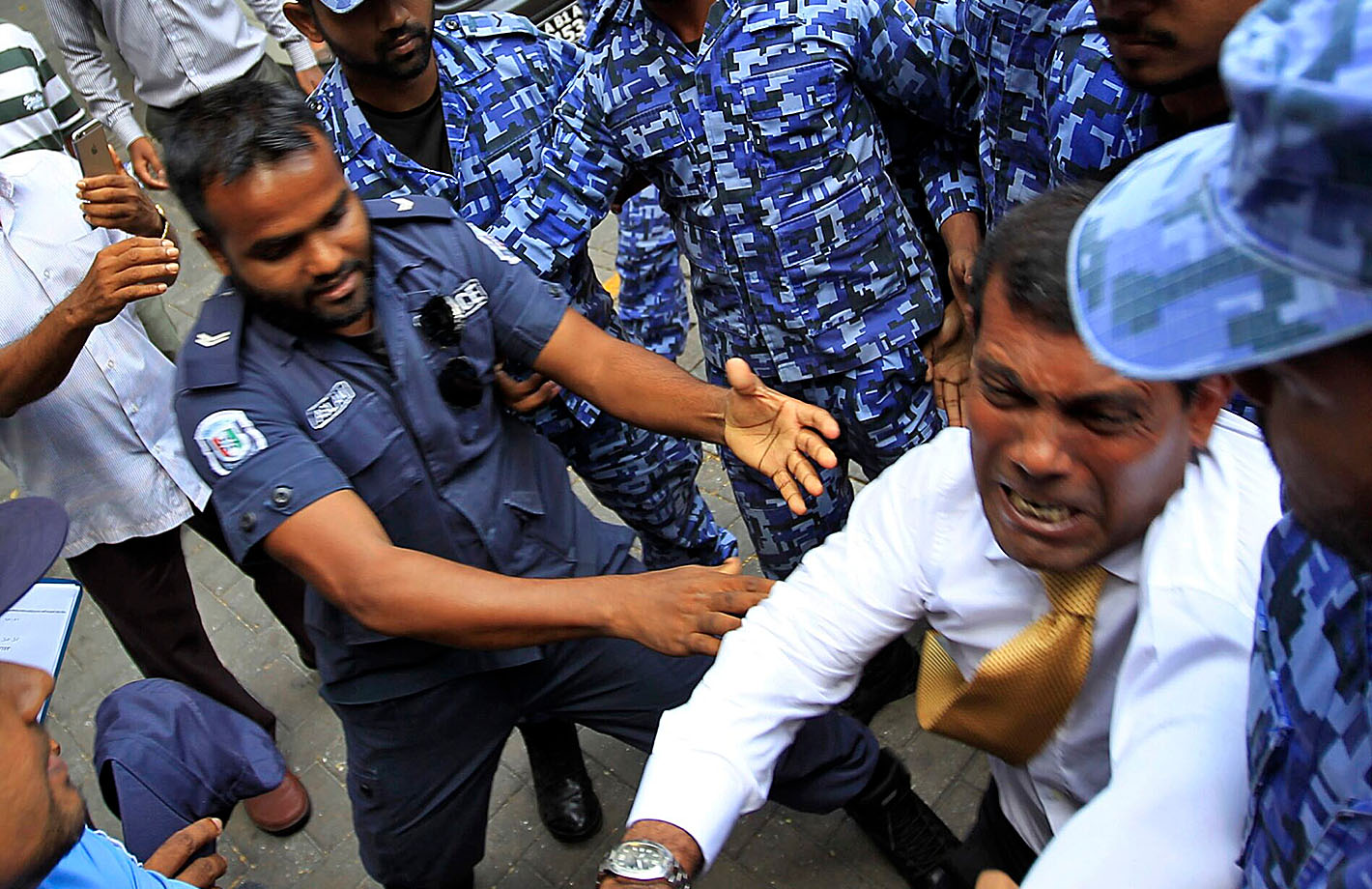 Mohamed Nasheed, former president of the Maldives, being detained.