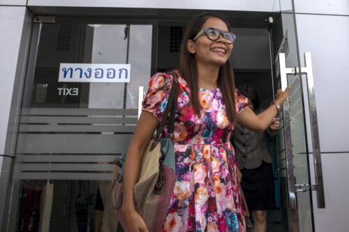 Thai journalist Chutima Sidasathian opens the door as she leaves court in Phuket, Thailand
